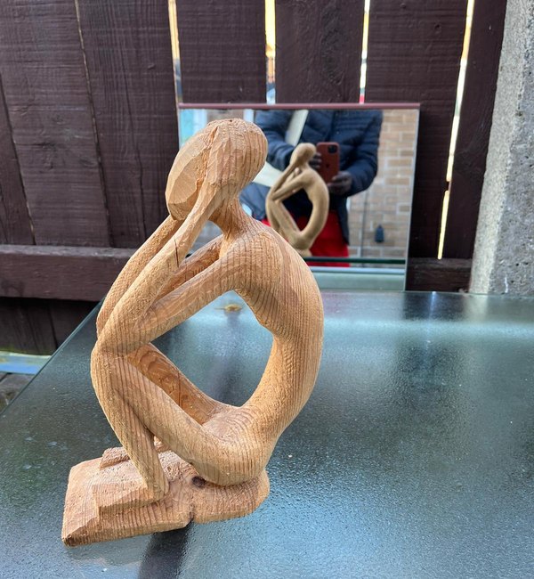 Seated contemplative wooden figure