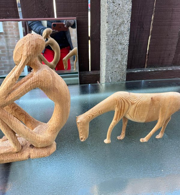 Figure carving beside a carved animal