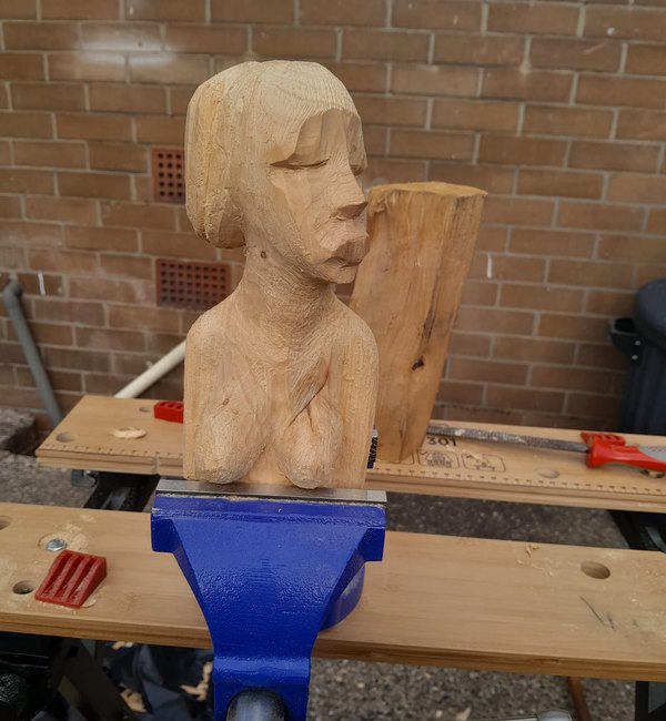 Carved portrait bust held in a vice